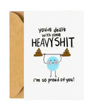 White encouragement card with proud of you message and beige envelope.