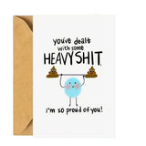 White encouragement card with proud of you message and beige envelope.