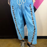 Aqua blue wide leg windbreaker pants with zebra side stripes and drawstring waist.