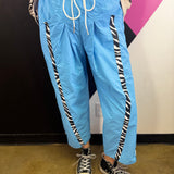 Aqua blue wide leg windbreaker pants with zebra side stripes and drawstring waist.