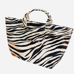 Zebra print PVC tote bag with large capacity and structured design, black and white stripes
