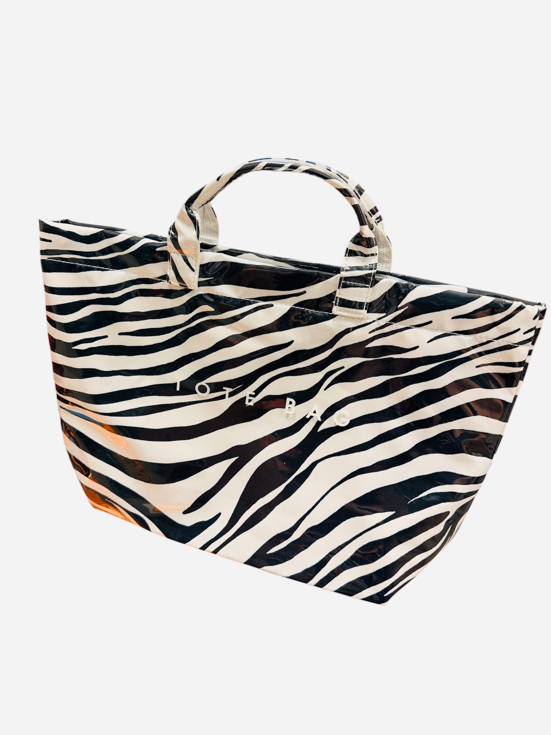 Zebra print PVC tote bag with large capacity and structured design, black and white stripes