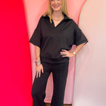 Black scuba matching set with collared short sleeve top and center seam pants.