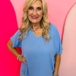 Cornflower Blue lightweight woven V-neck top with short sleeves and relaxed fit