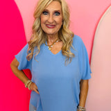 Cornflower Blue lightweight woven V-neck top with short sleeves and relaxed fit
