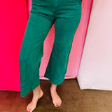 Dark green wide leg cropped jeans with front pintuck detail and relaxed fit.