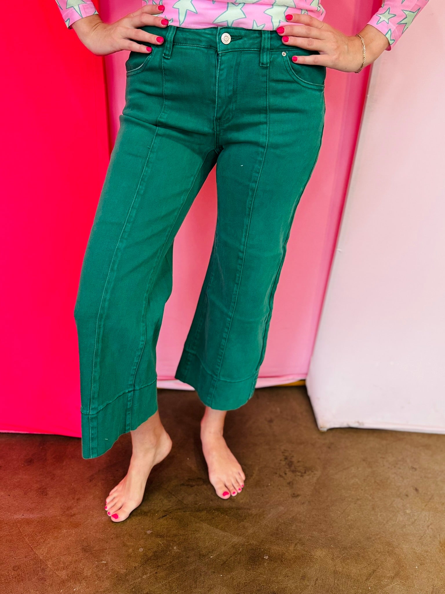 Dark green wide leg cropped jeans with front pintuck detail and relaxed fit.