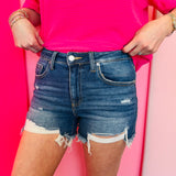 Zenana Dark wash distressed hem denim shorts with stretch fabric and flattering mid-to-high rise fit.