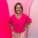 Hot pink lightweight woven V-neck top with short sleeves and relaxed fit