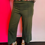Olive wide-leg pants with front pintuck seam, elastic waistband, and structured ponte fabric.
