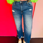 Dark distressed jeans with raw hem and stretch fit.