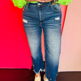 Dark distressed jeans with raw hem and stretch fit.