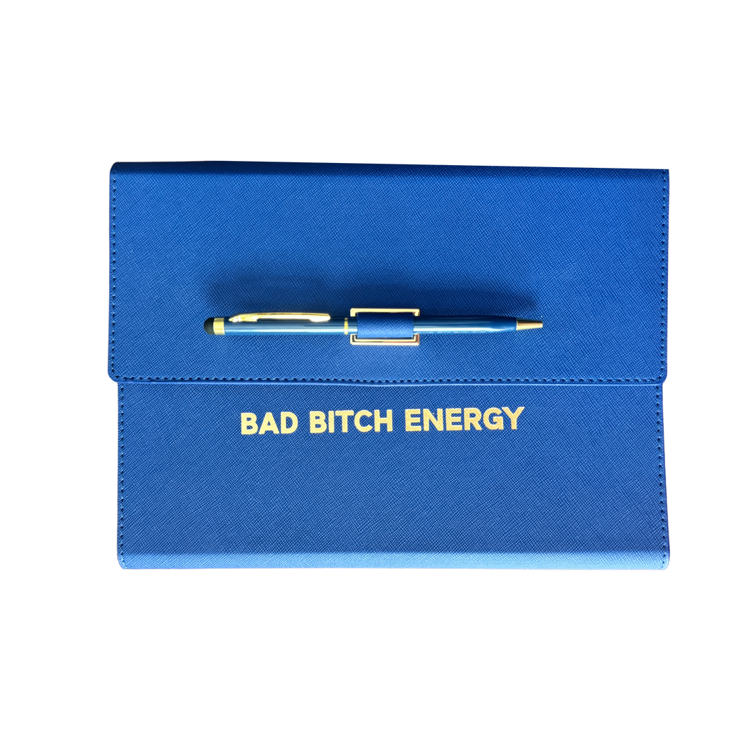 Blue clutch journal folio and calendar with 'BAD BITCH ENERGY' text and colored pen.