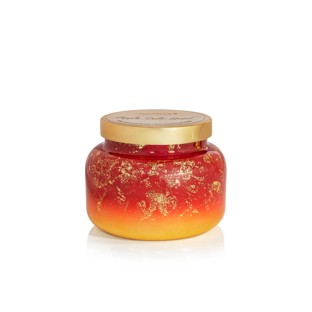 19oz Capri Blue Apple Cider Social Glimmer Candle in cranberry red and gold.
