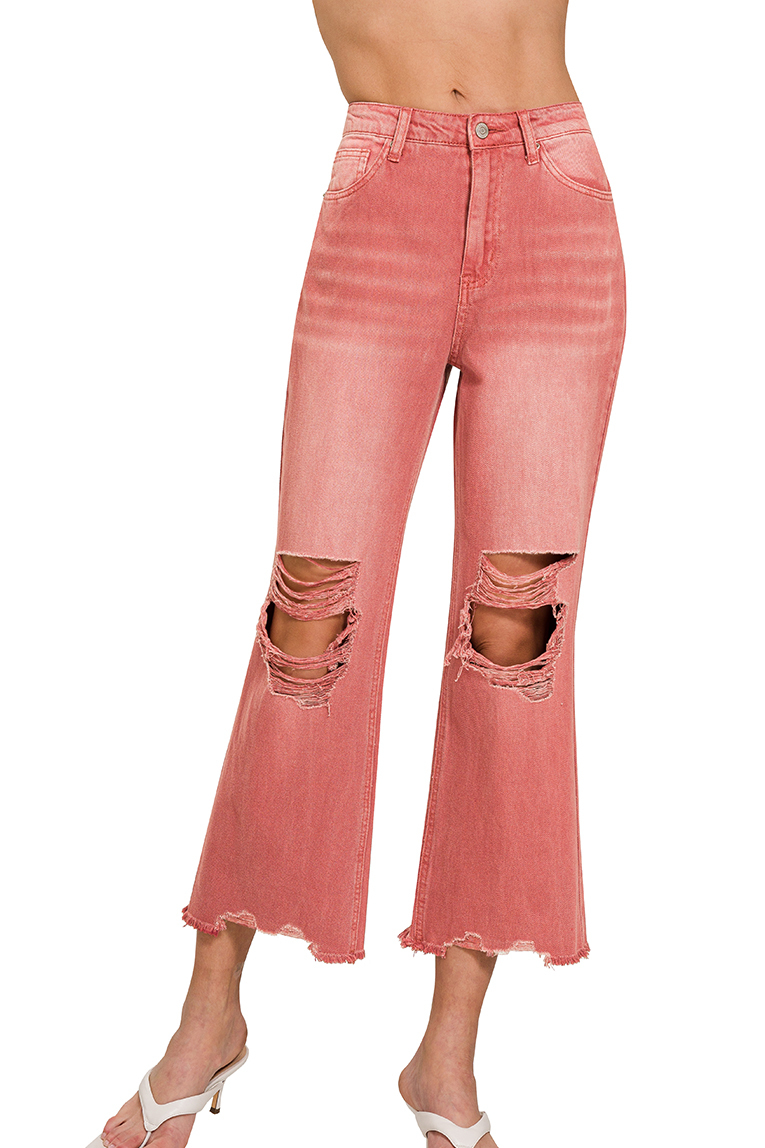 Cropped cabernet-washed jeans with knee and hem distressing, laid flat to show color and texture.