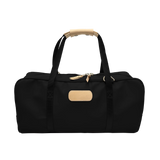 Jon Hart Carry-All duffel in coated canvas with natural leather trim, shoulder strap, and trolley sleeve.