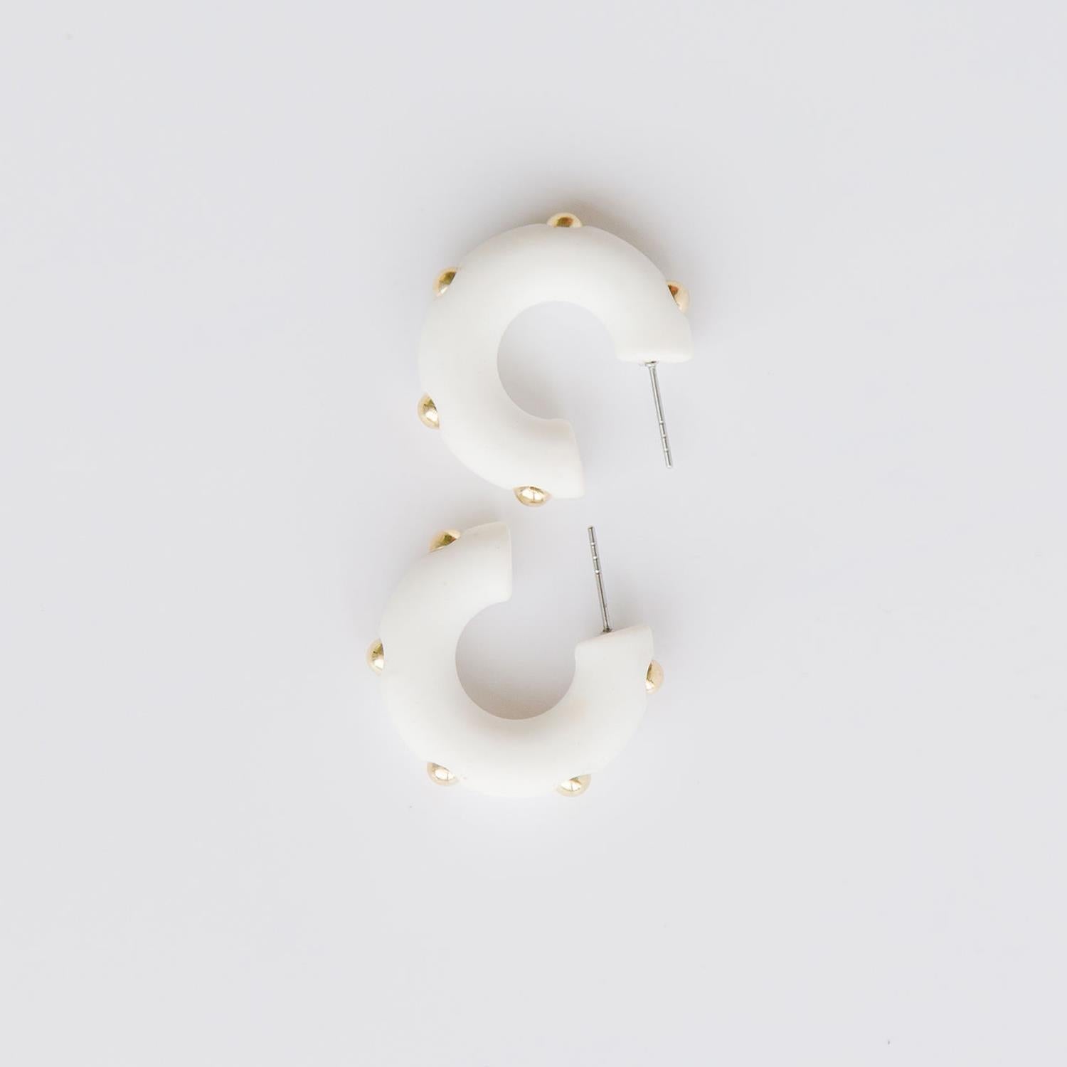 Candace white hoop earrings with gold studs. 