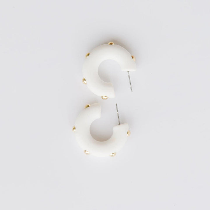 Candace white hoop earrings with gold studs. 