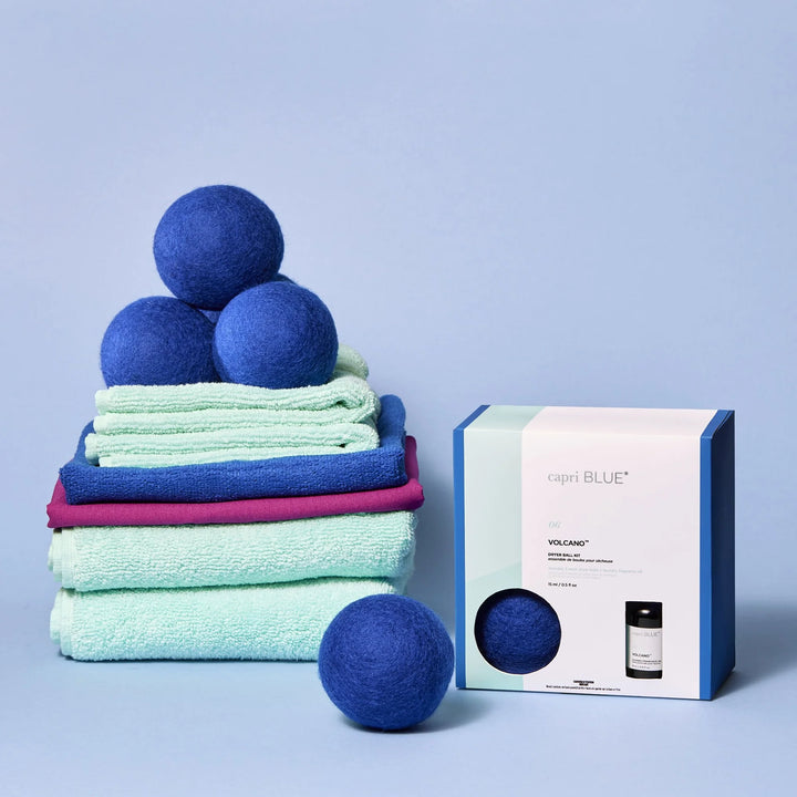 Volcano Dryer Ball Kit with cobalt blue wool balls and citrus-scented fragrance oil for soft, fresh laundry