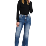 Blue denim kick crop flare jeans. The jeans have a high-waisted fit, are snug through the thigh, and flare out slightly above the ankle, showing the person's footwear.