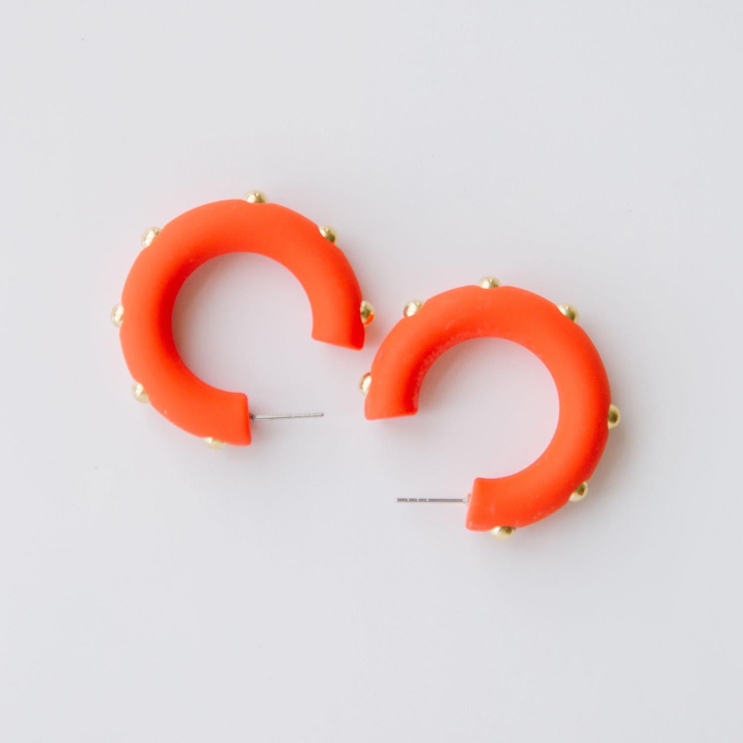 Candace clementine orange hoop earrings with gold studs. 