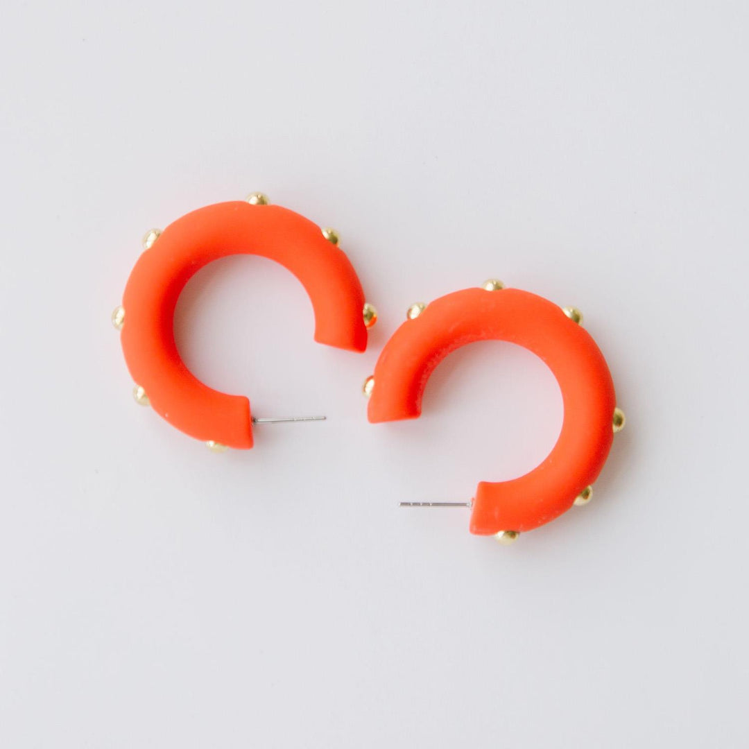 Candace clementine orange hoop earrings with gold studs. 