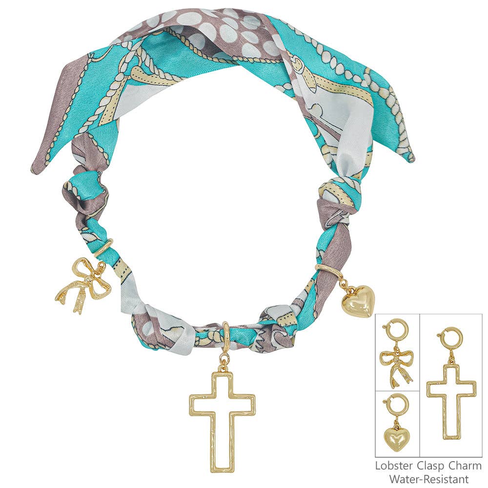 teal and white knotted scarf necklace with removable heart, cross, and bow charms.