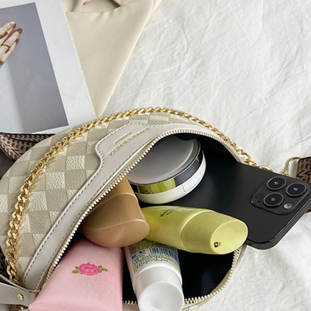 Open view of the cream checkered fanny pack with gold chain accent