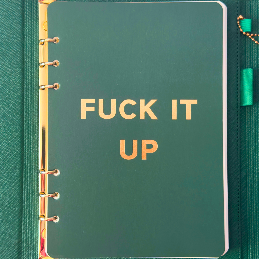 Inside cover of green clutch folio journal with calender and matching pen. 'FUCK IT UP' gold foil text.