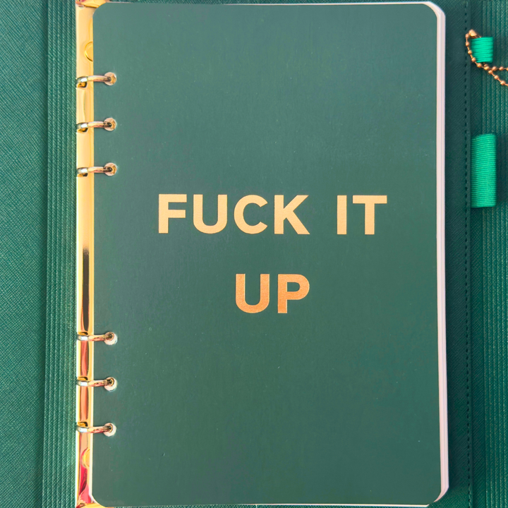 Inside cover of green clutch folio journal with calender and matching pen. 'FUCK IT UP' gold foil text.