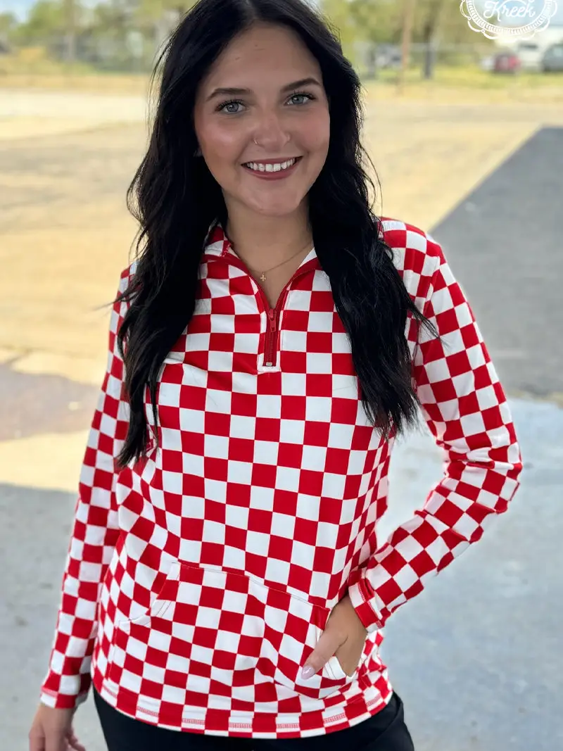 Red and white checkered pullover with collared neckline, quarter-zip front, and kangaroo pocket, laid flat to highlight pattern and details.