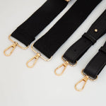 Adjustable strap on clear football-shaped crossbody bag with black trim
