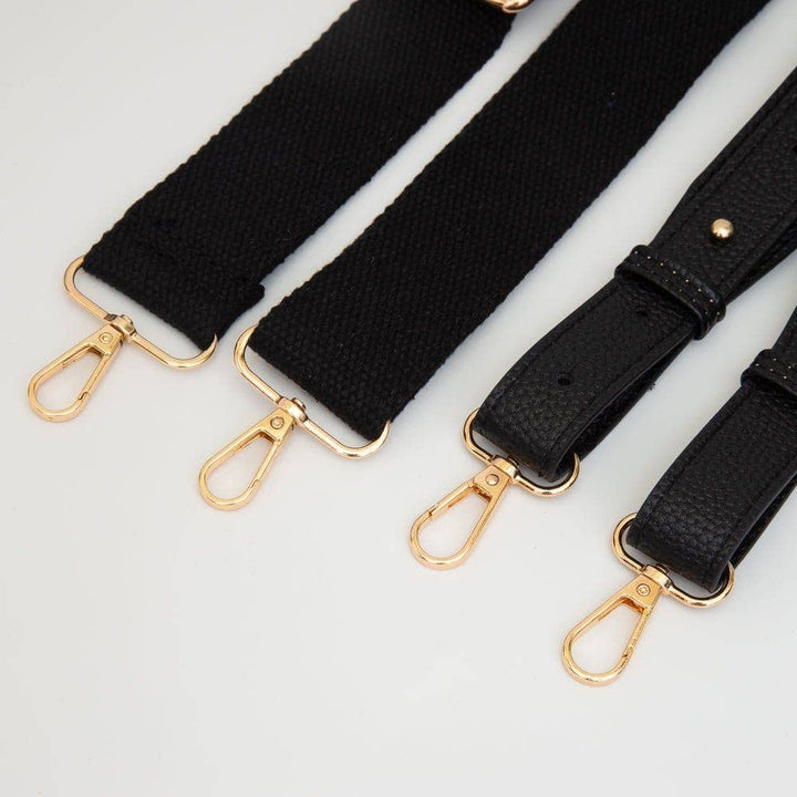 adjustable strap on clear football-shaped crossbody bag with black trim