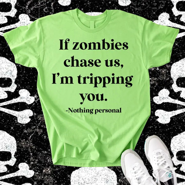 “If zombies chase us, I'm tripping you. Nothing personal,” lime green Halloween graphic tee.