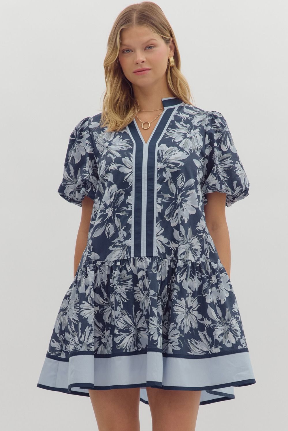 Navy floral print mini dress with white flowers, bubble sleeves, ruffle hem.
