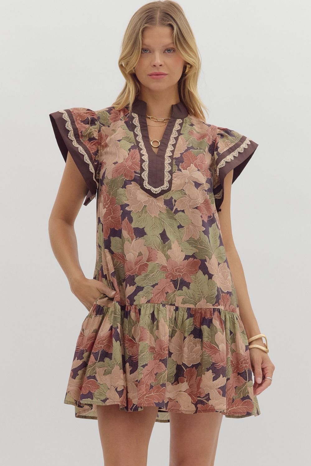 Brown floral print mini dress with flutter sleeves and tiered hem.