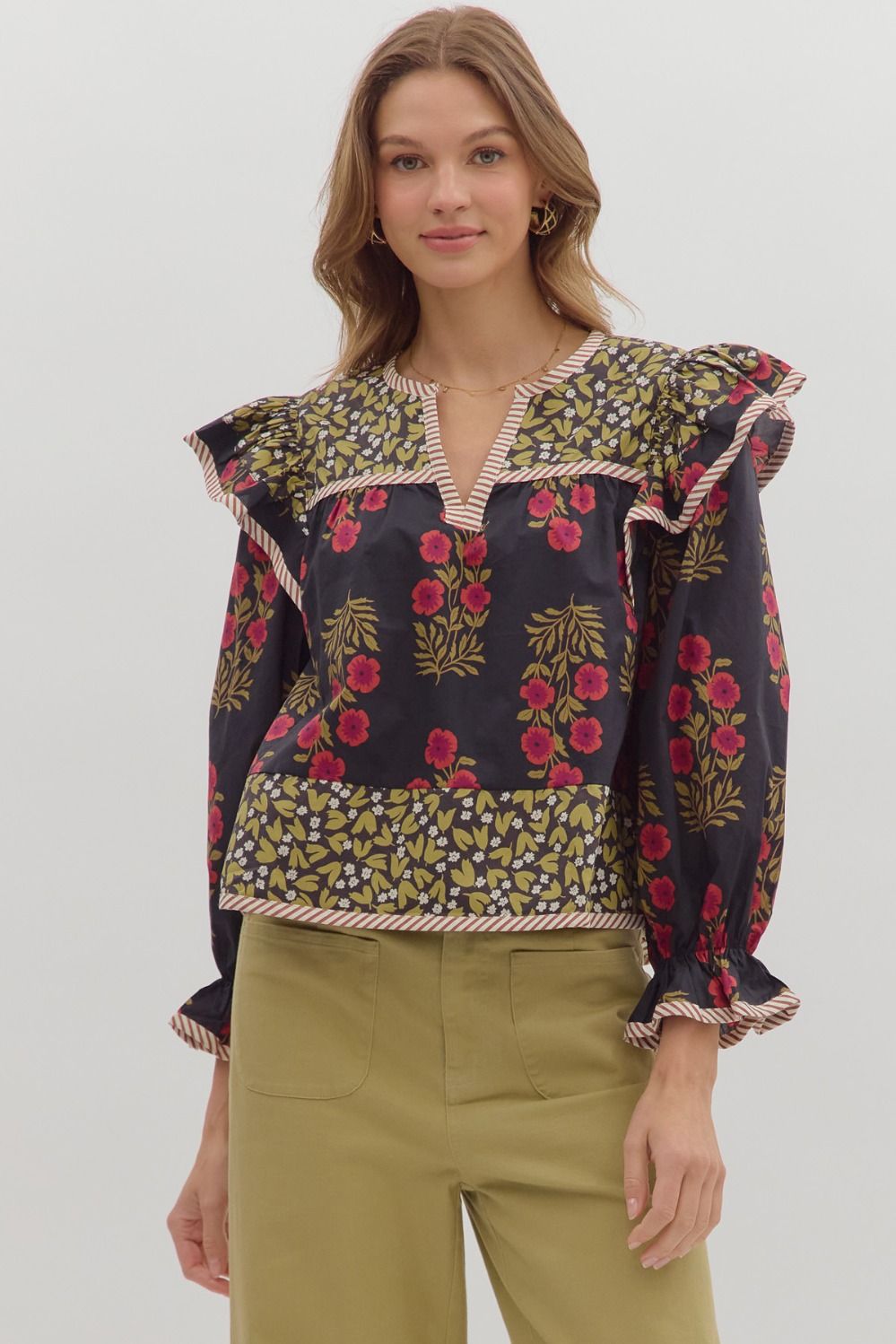 Black multi-print puff sleeve top with red and gold florals, ruffle shoulders.