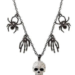 Halloween multi-charm necklace with spiders, skull hands, and a silver skull pendant.