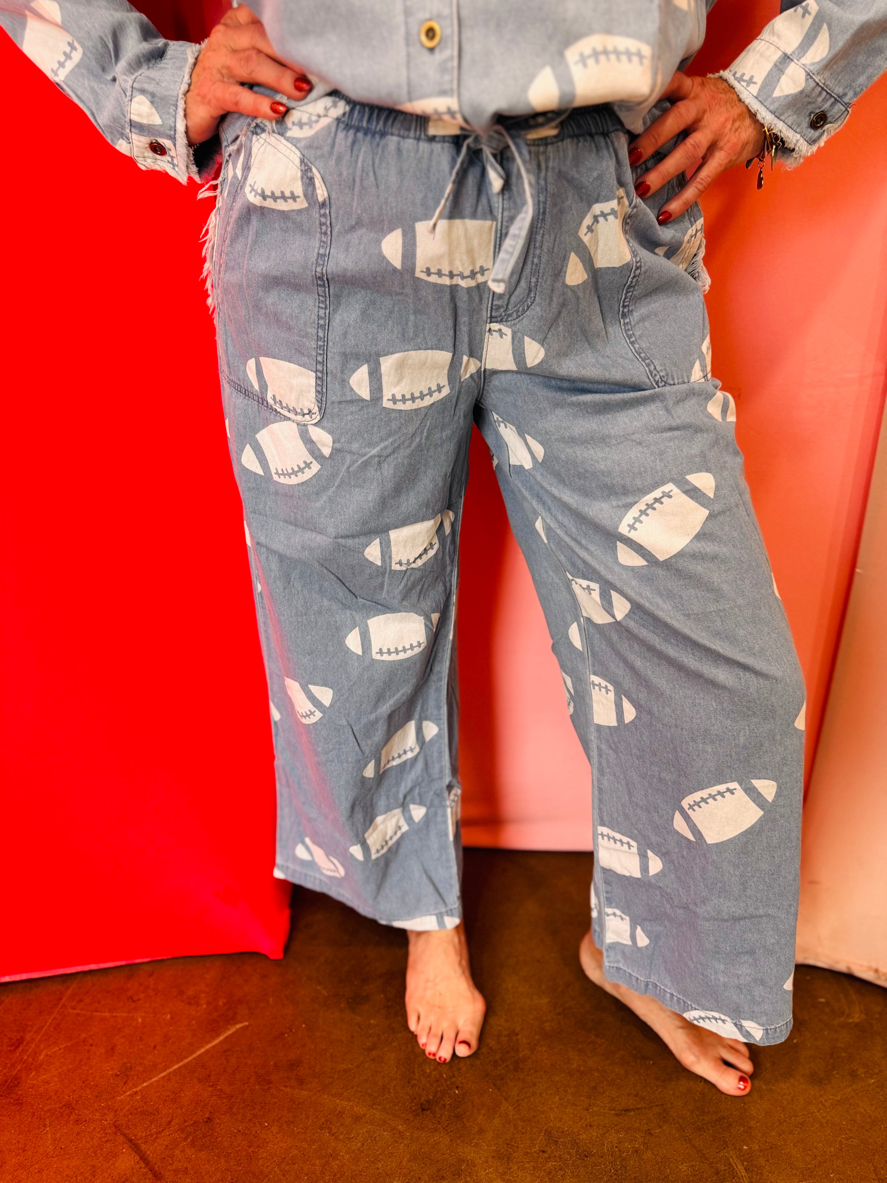 Chambray wide leg pants with white football print and drawstring waist.