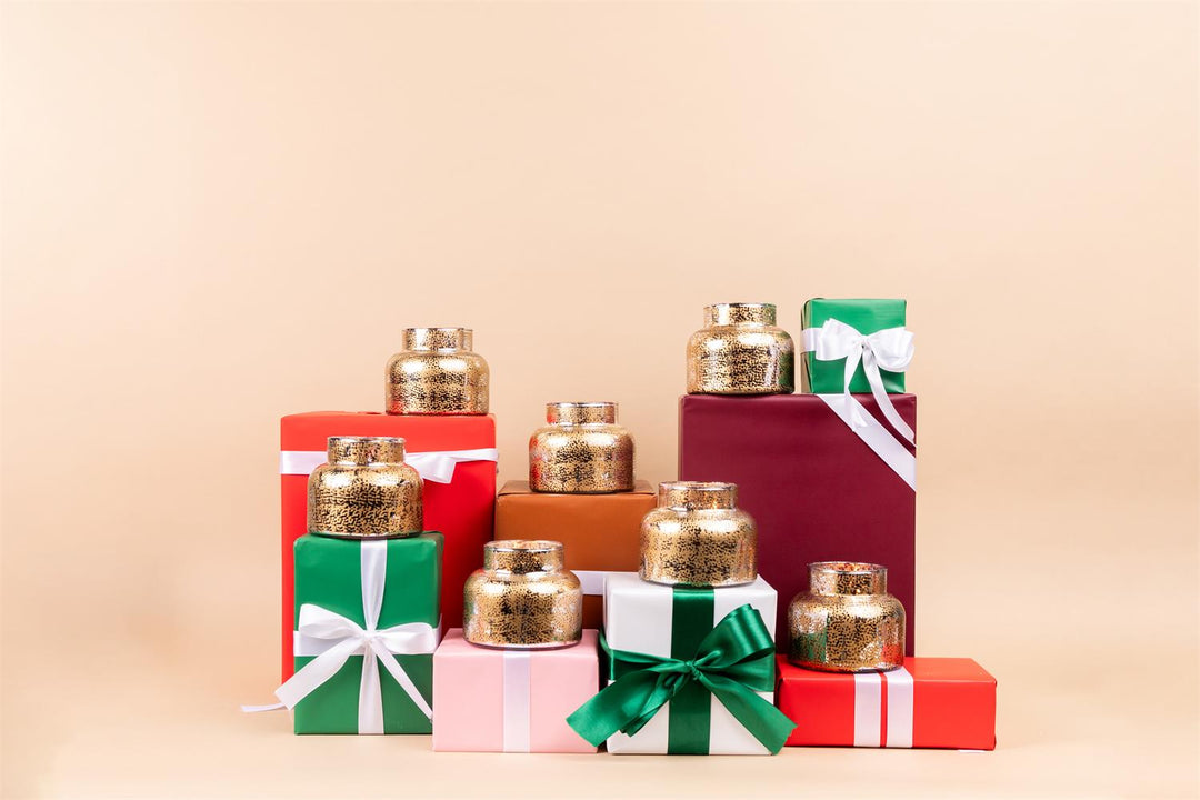 Sweet Grace Holiday Candle display on Christmas boxes.