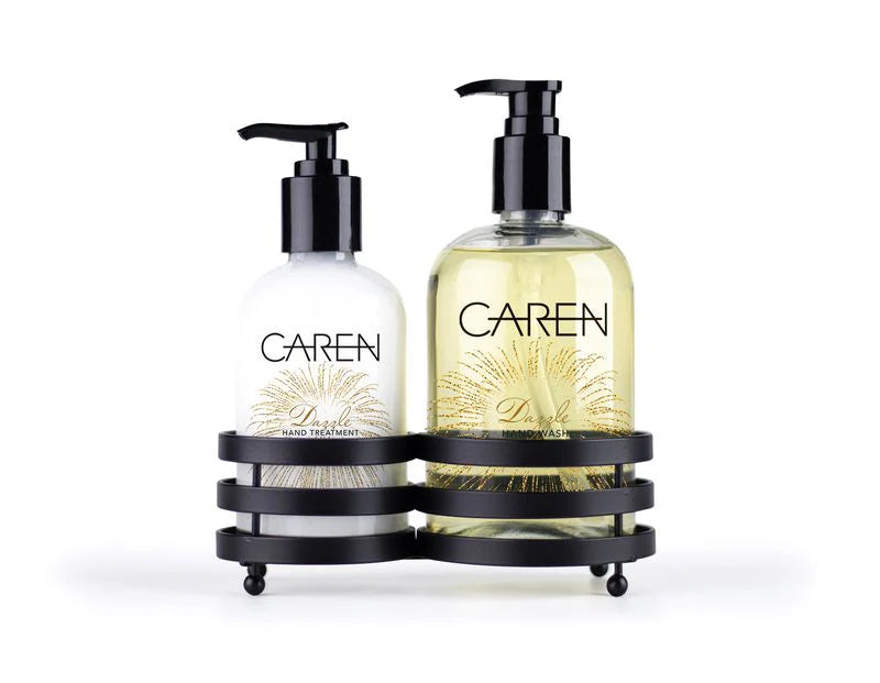 A 14 oz bottle of "Dazzle" hand wash and a 14 oz bottle of hand treatment sitting in a black sink-side caddy.