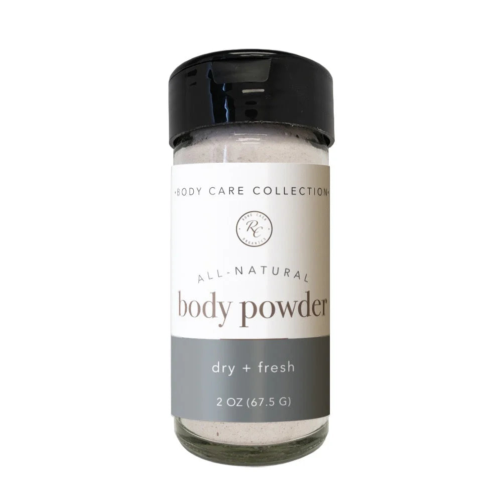 All-natural body powder in a glass jar with a black lid on a white background