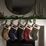 Jon Hart holiday stocking in coated canvas with leather trim and customizable leather patch for personalization.