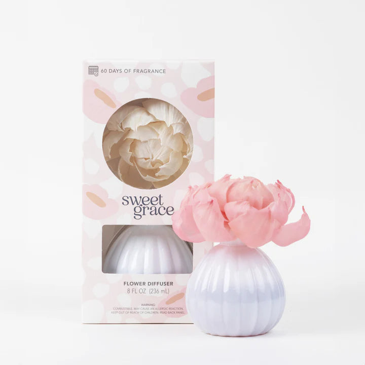 Flower diffuser with pink flower and packaging labeled 'sweet grace' on a white background