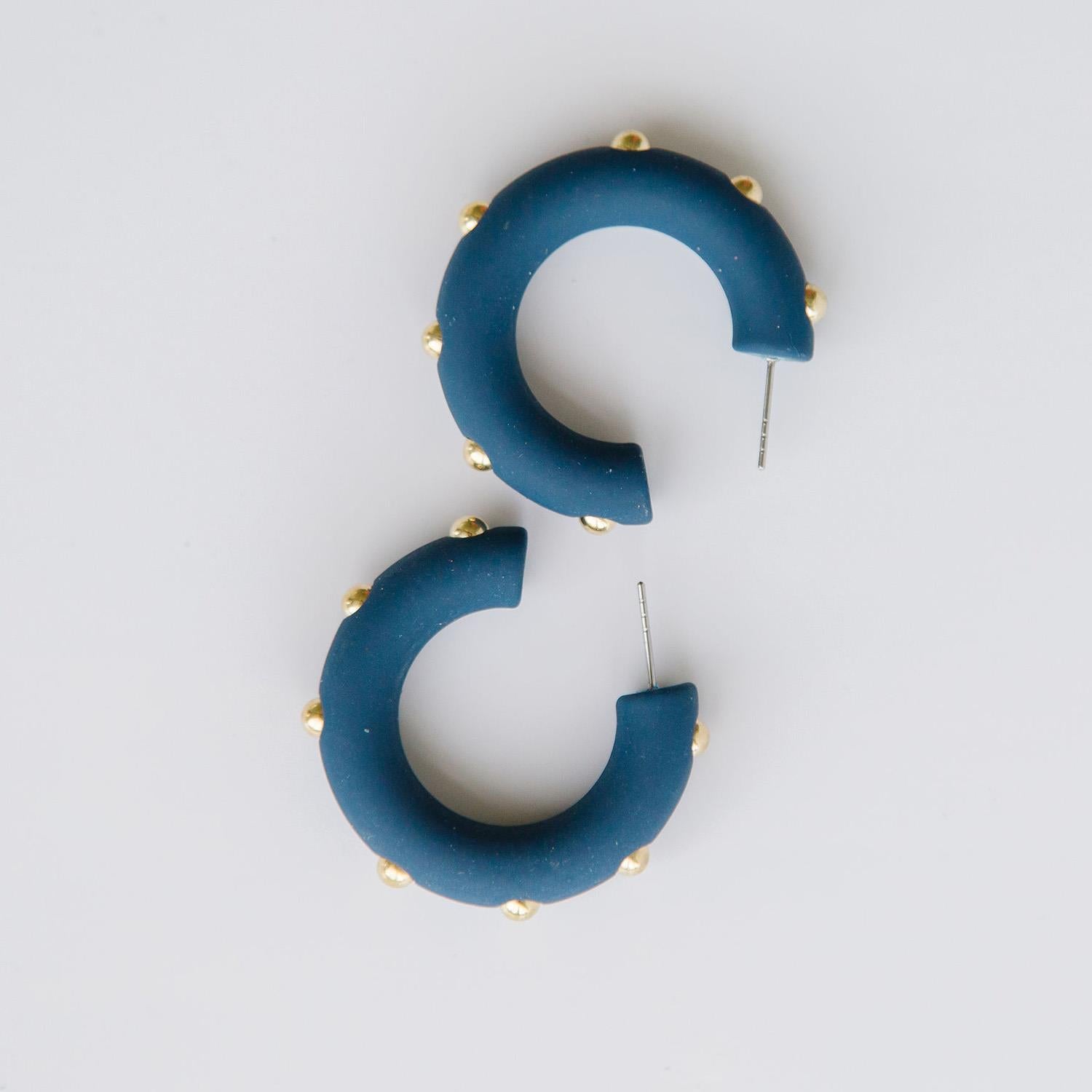 Candace navy hoop earrings with gold studs. 
