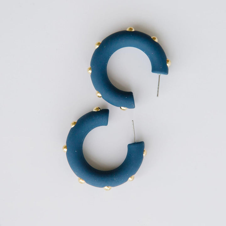 Candace navy hoop earrings with gold studs. 