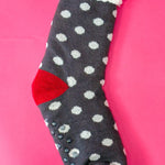 Navy polka dot sherpa-lined cabin socks with red accents and non-slip soles.