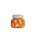 An 8oz Capri Blue Pumpkin Dulce Petite Candle with a festive holiday pattern.