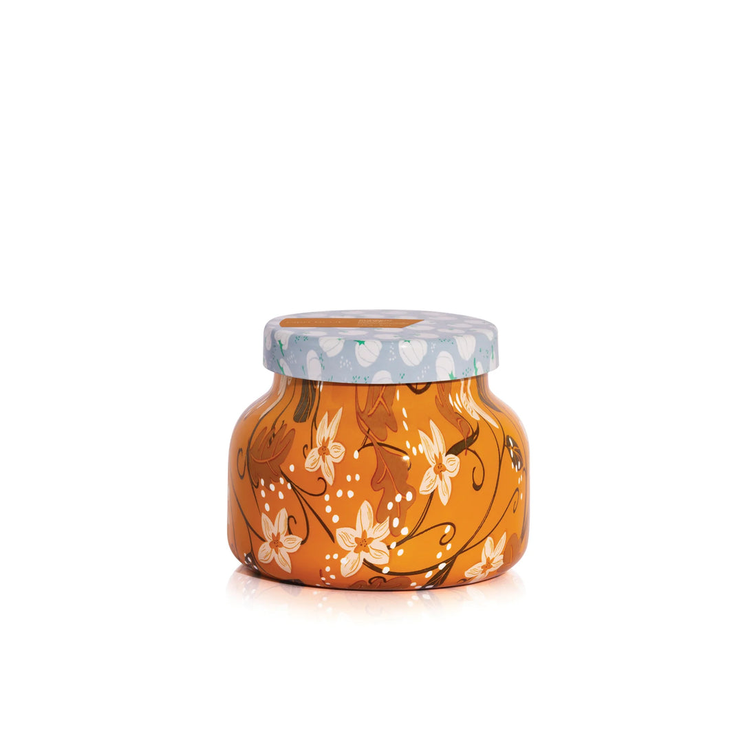 An 8oz Capri Blue Pumpkin Dulce Petite Candle with a festive holiday pattern.