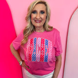 Pink teacher graphic tee with colorful polka dot lettering